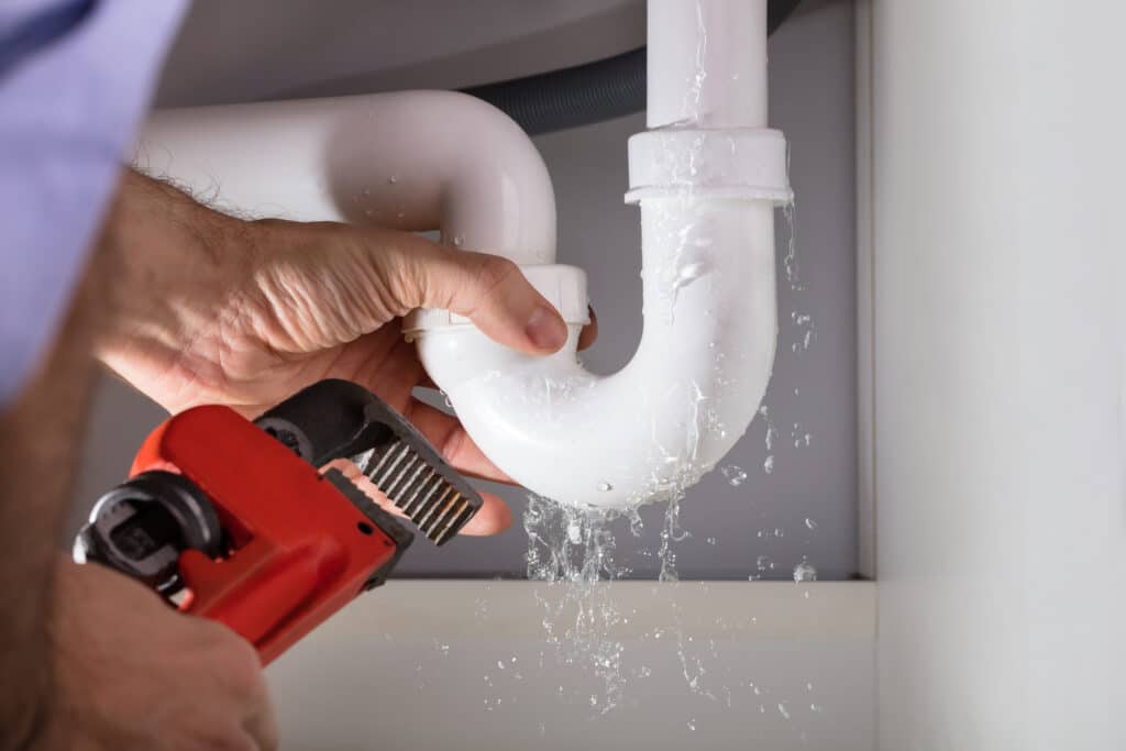 Plumbing Repair, Sink Pipe With Adjustable Wrench.