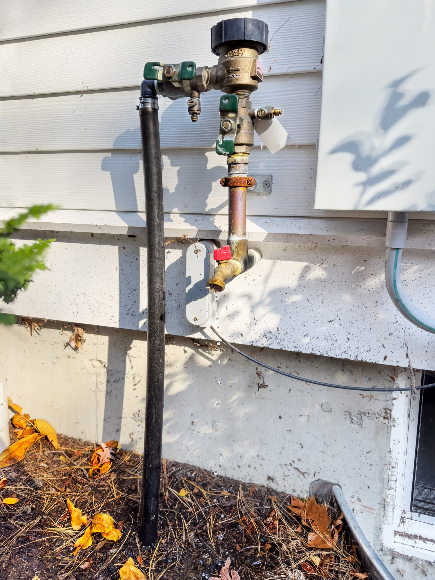 Valve Troubleshooting Basics Every Homeowner Should Know 1 Plumber performing valve troubleshooting on a leaking outdoor faucet.